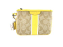 COACH CORNER ZIP WRISTLET IN SIGNATURE CANVAS YELLOW