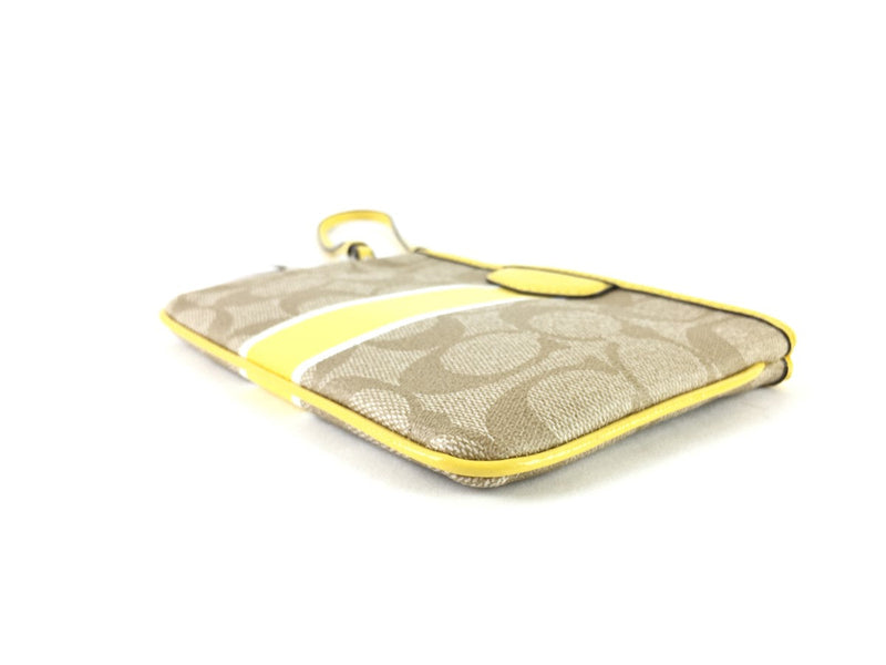 COACH CORNER ZIP WRISTLET IN SIGNATURE CANVAS YELLOW