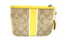 COACH CORNER ZIP WRISTLET IN SIGNATURE CANVAS YELLOW